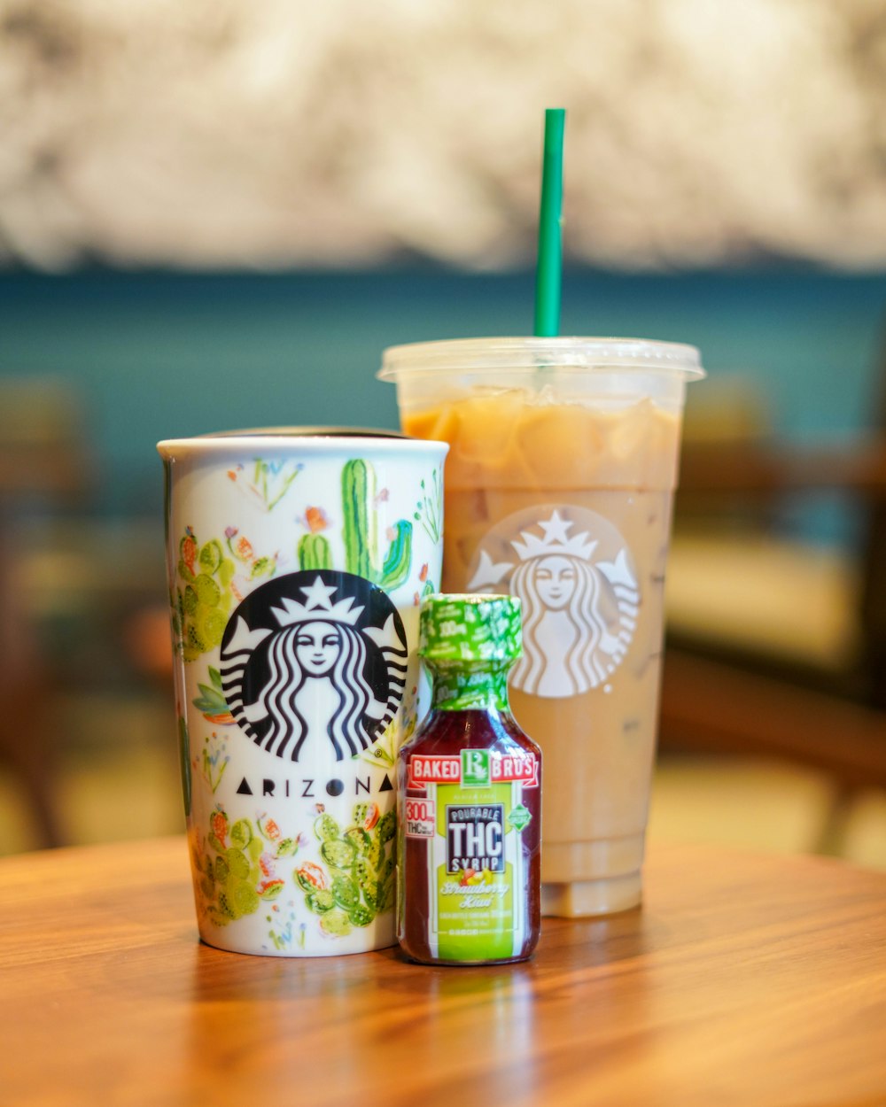 two white and green plastic cups on brown wooden table