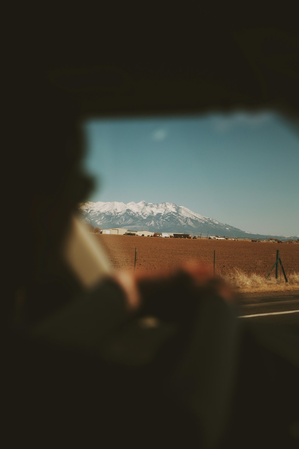 gray asphalt road near snow covered mountain during daytime