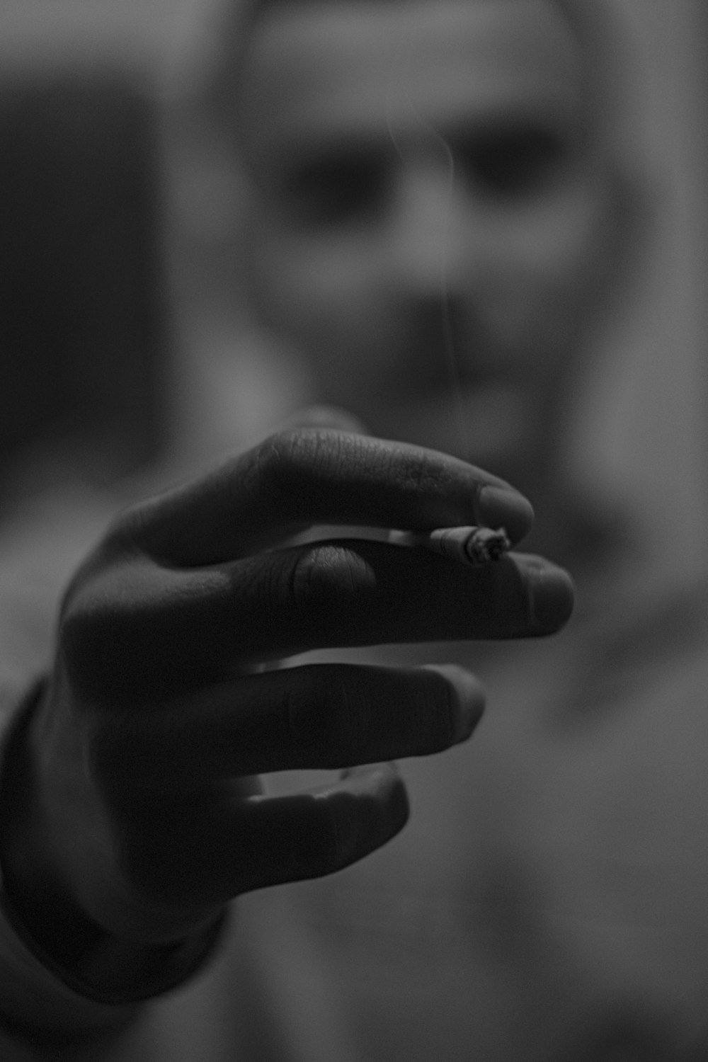 grayscale photo of persons hand with ring