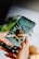 A close-up of a smartphone displaying a cooking app with vibrant food images.