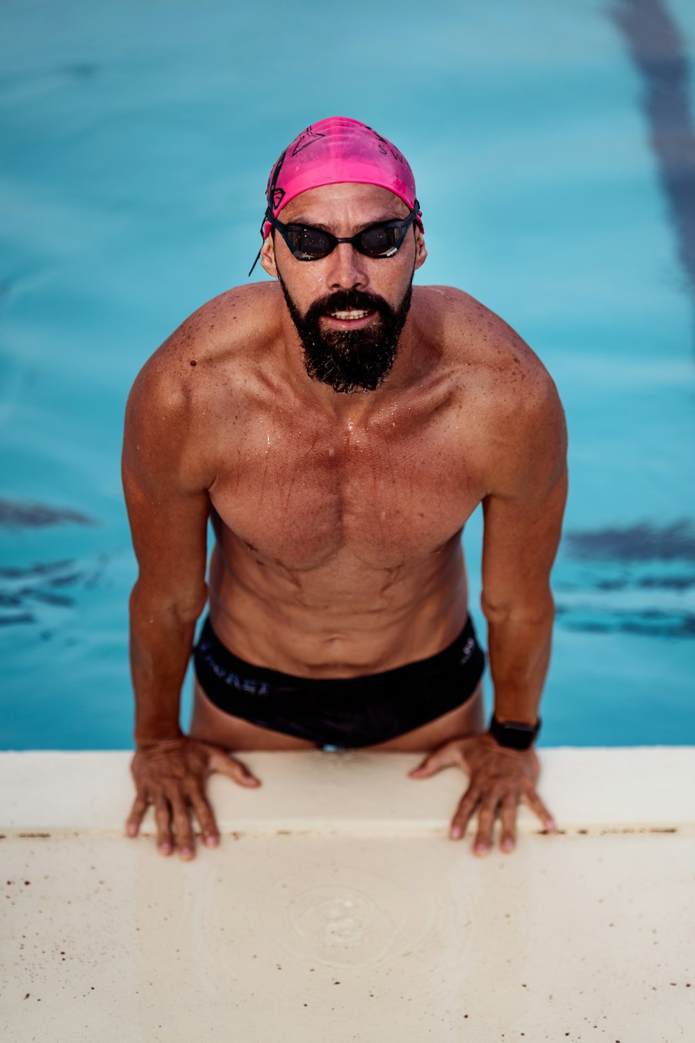 man in black shorts wearing sunglasses standing on water during daytime