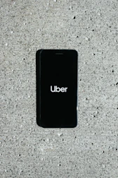 An Uber driver receiving payment through a mobile app for displaying ads on their car.