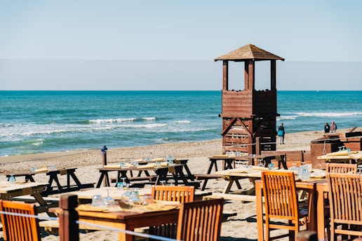 brown wooden lifeguard tower on beach during daytime