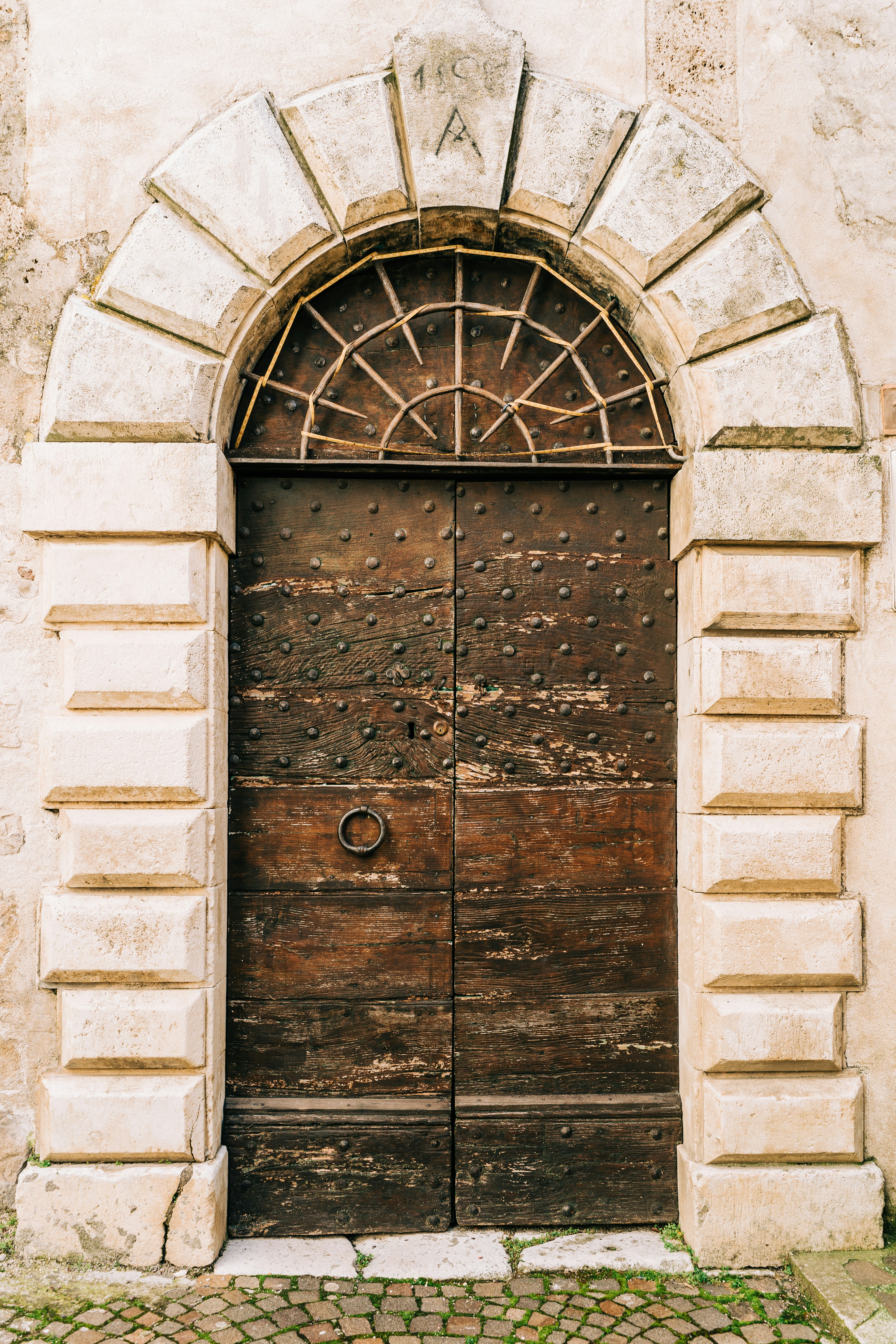 brown wooden door on gray concrete brick wall