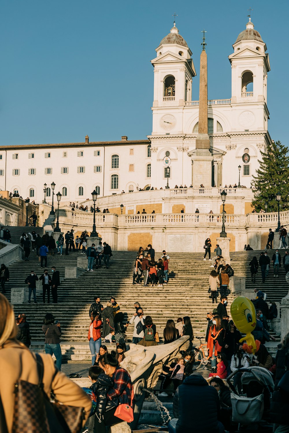 people sitting on bench near building during daytime