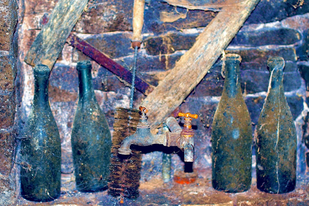 green glass bottles on brown wooden rack