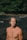 topless woman standing on brown field during daytime