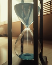 A softly glowing hourglass symbolizing anticipation and the passage of time.