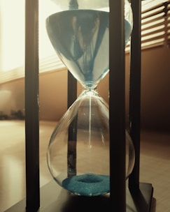 A softly glowing hourglass symbolizing anticipation and the passage of time.