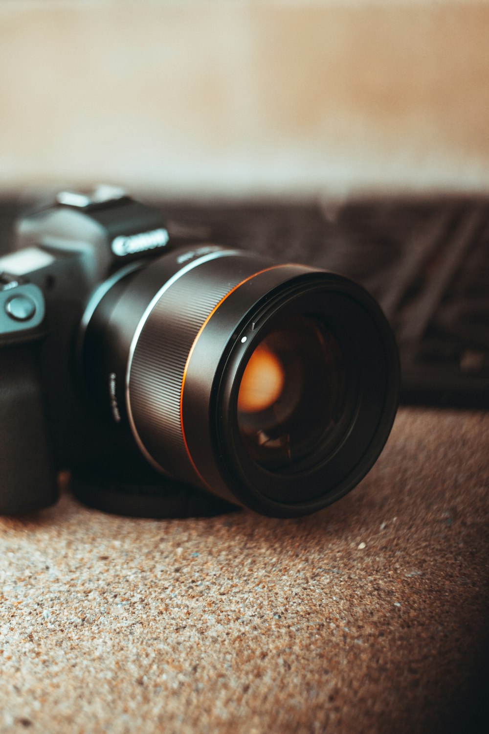 black nikon dslr camera on brown textile