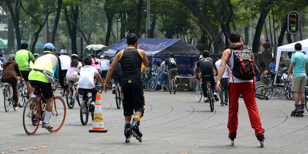 people riding bicycle on road during daytime