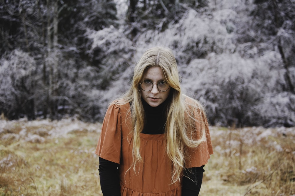 woman in red long sleeve shirt wearing black framed eyeglasses