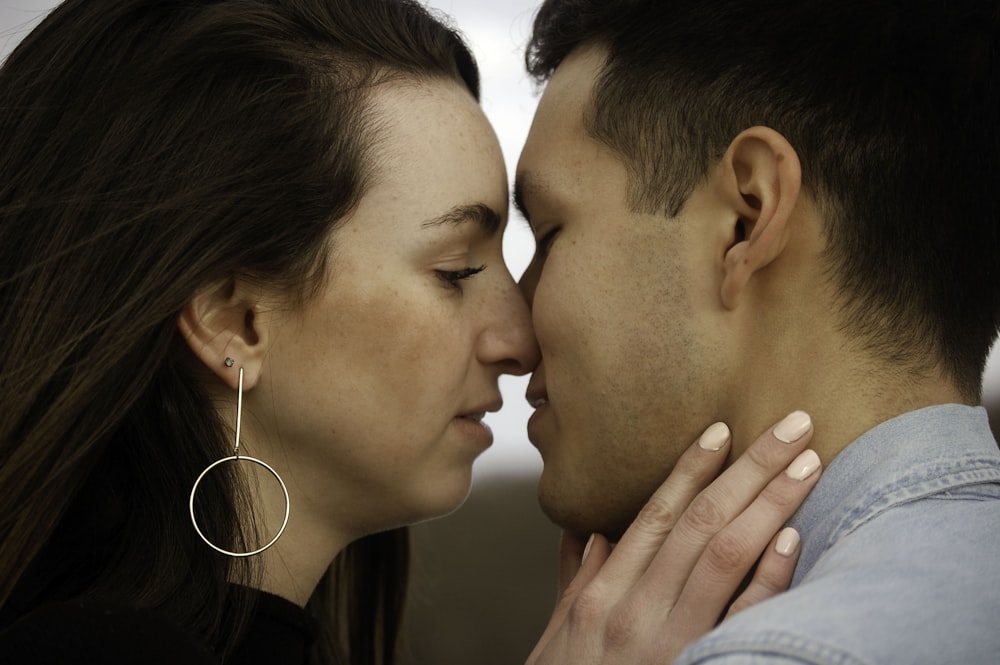 man and woman kissing each other