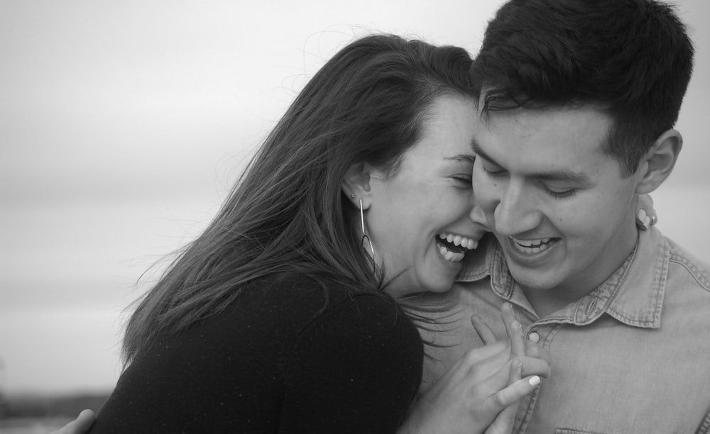 grayscale photo of man and woman smiling