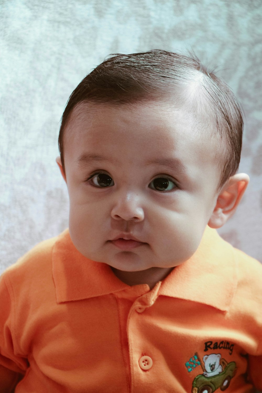 child in orange polo shirt