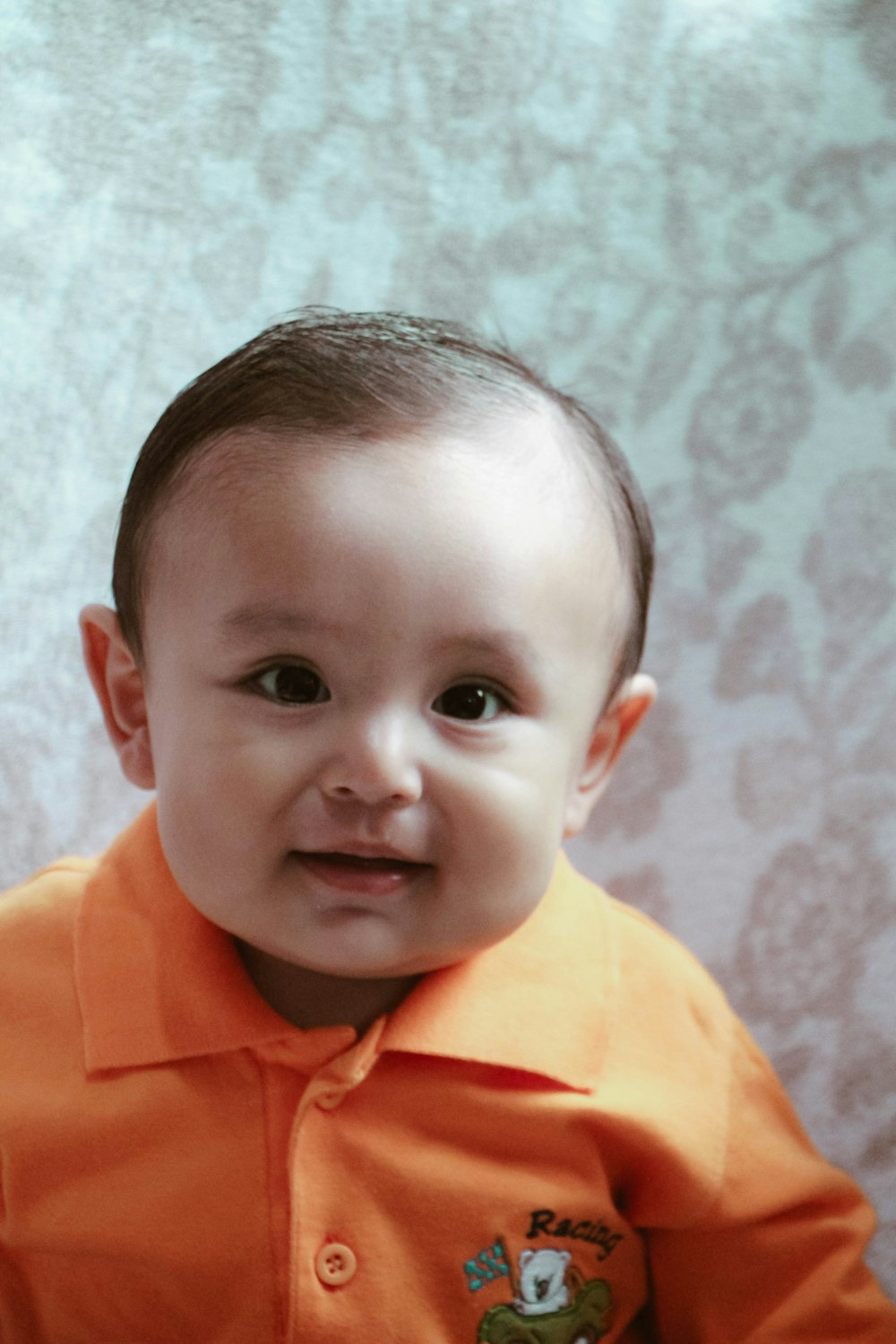 boy in orange polo shirt