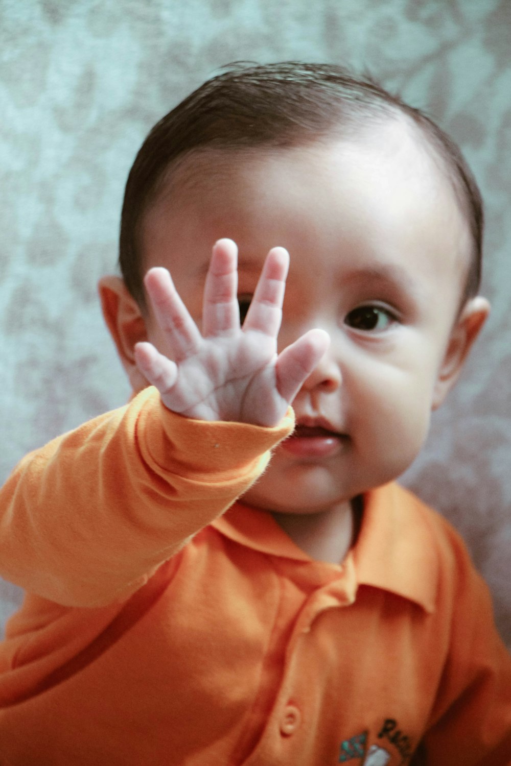 boy in orange polo shirt