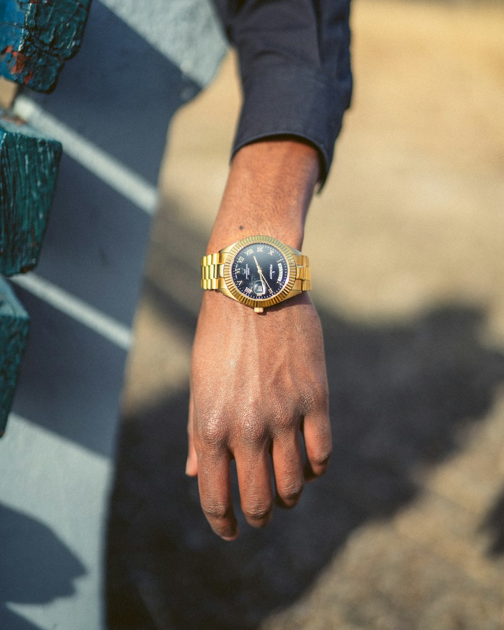 person wearing gold and black analog watch