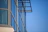 Close-up of sleek aluminum window frames reflecting a clear blue sky.