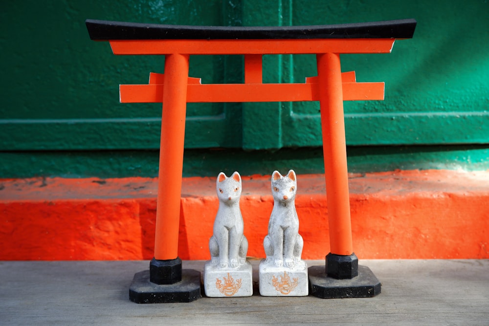 white cat and cat ceramic figurines