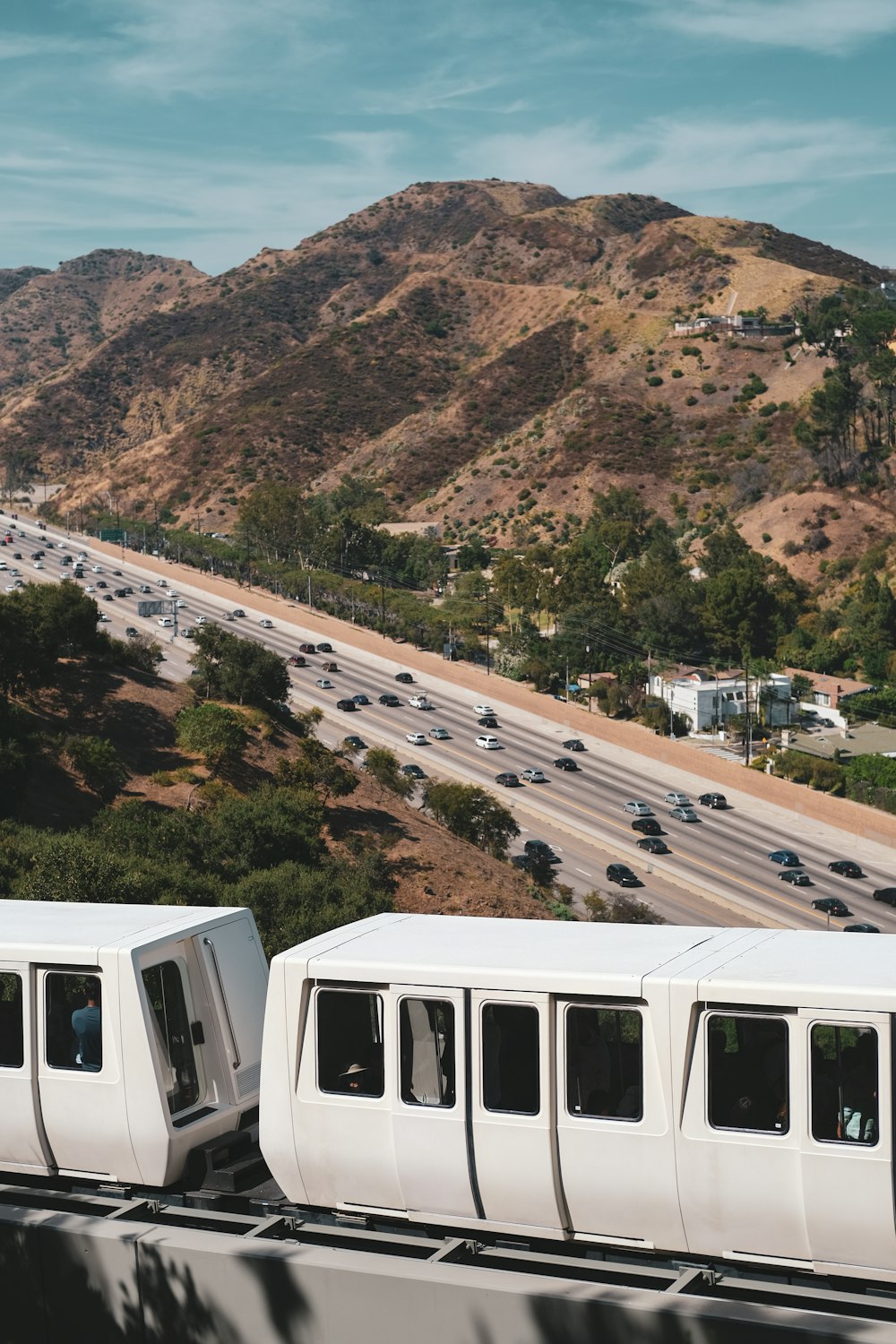 white and black cable car on brown and green mountain during daytime