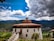A traditional Bhutanese home nestled among lush green hills.