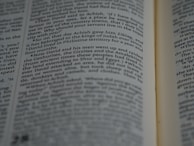 Close-up of hands flipping through pages of a thick legal research report.