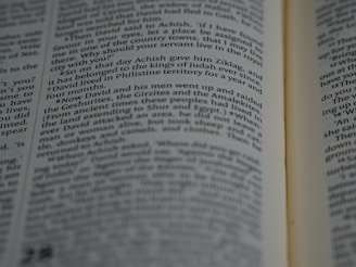 Close-up of hands flipping through a detailed tax textbook.