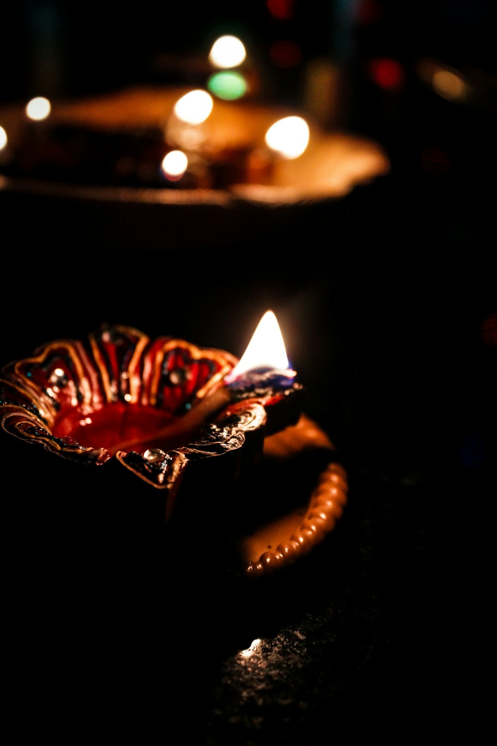 lighted candle on black holder