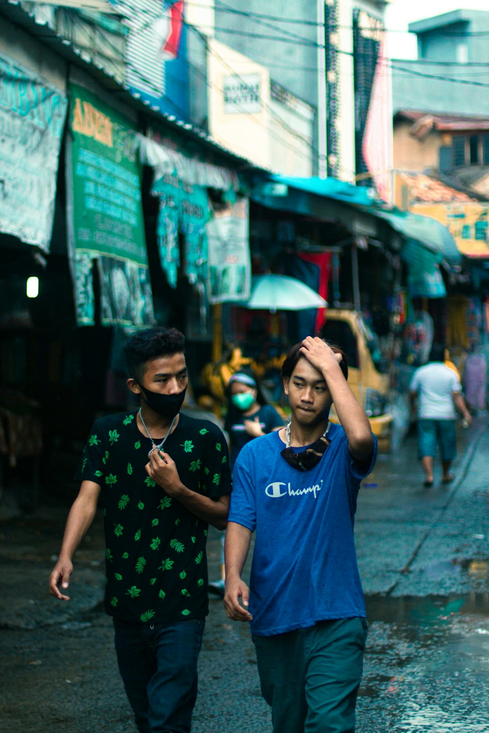 man in blue crew neck t-shirt standing beside woman in black and white polka dot