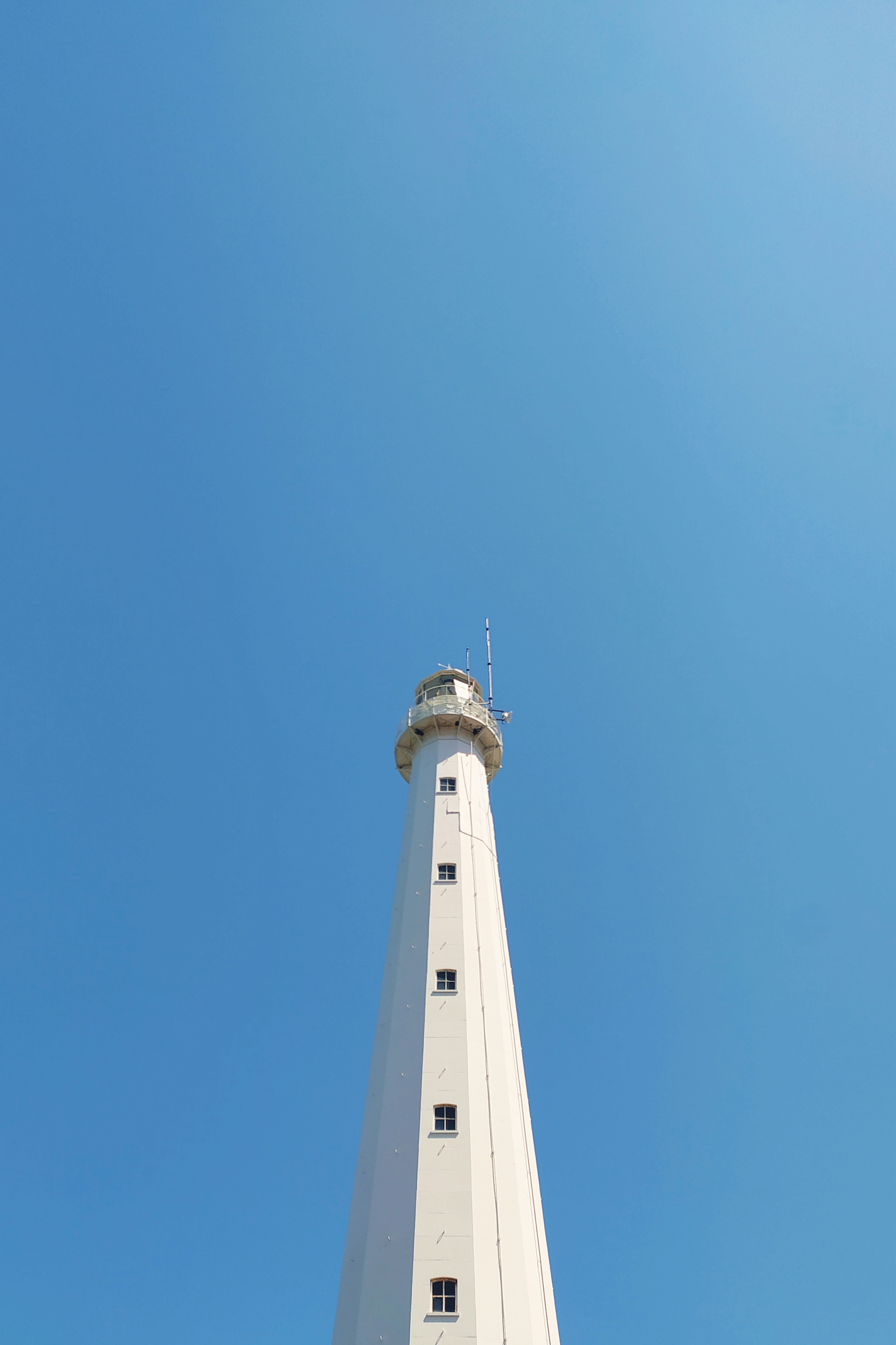 white concrete tower under blue sky during daytime
