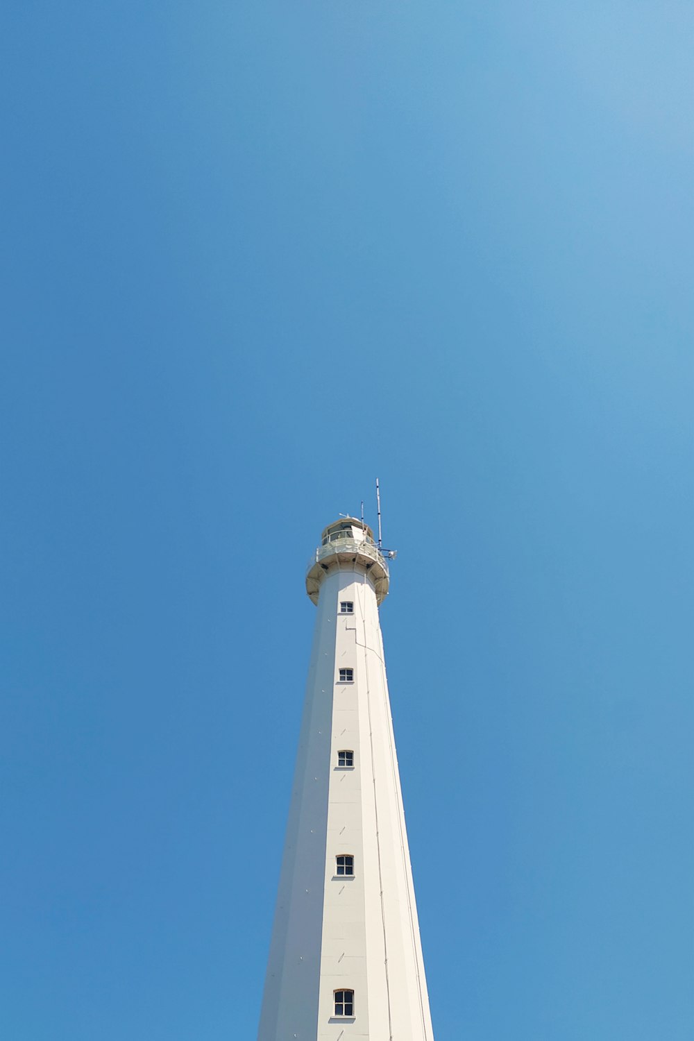 white concrete tower under blue sky during daytime