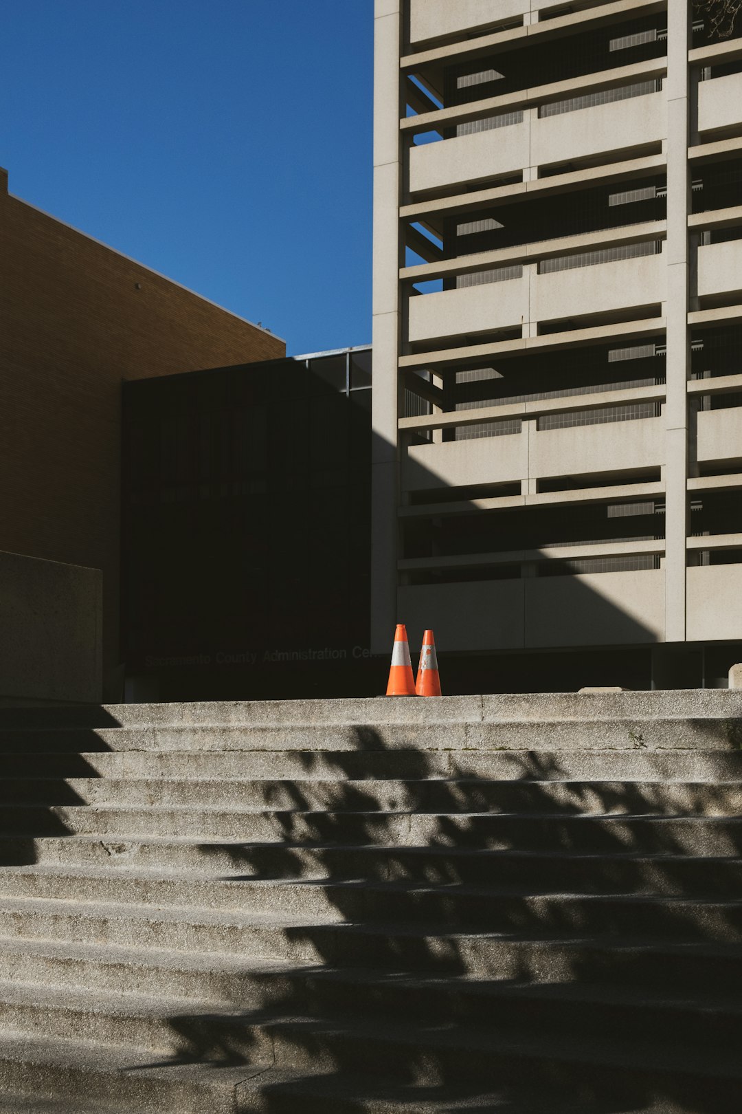 orange traffic cone on gray concrete stairs