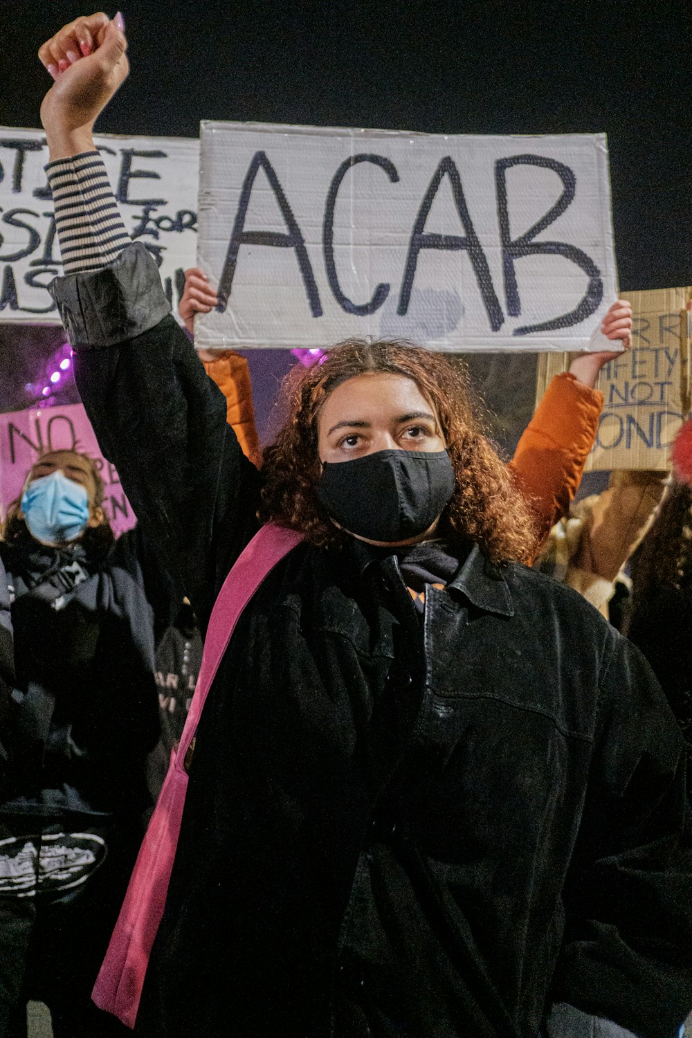 woman in black jacket wearing black mask