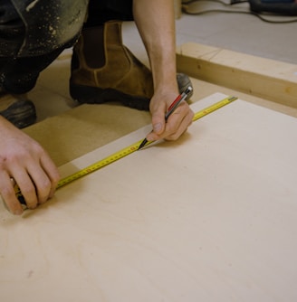 person holding yellow and black tape measure