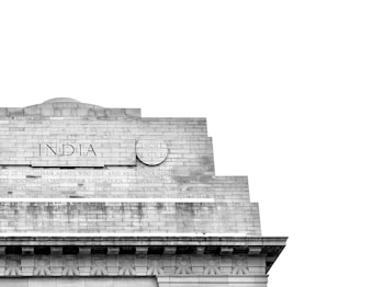 A detailed view of a section of a stone monument featuring the word 'INDIA' engraved prominently. Below, an inscription honors the Indian armies who served in various regions such as Mesopotamia, and there are decorative elements along the edges.