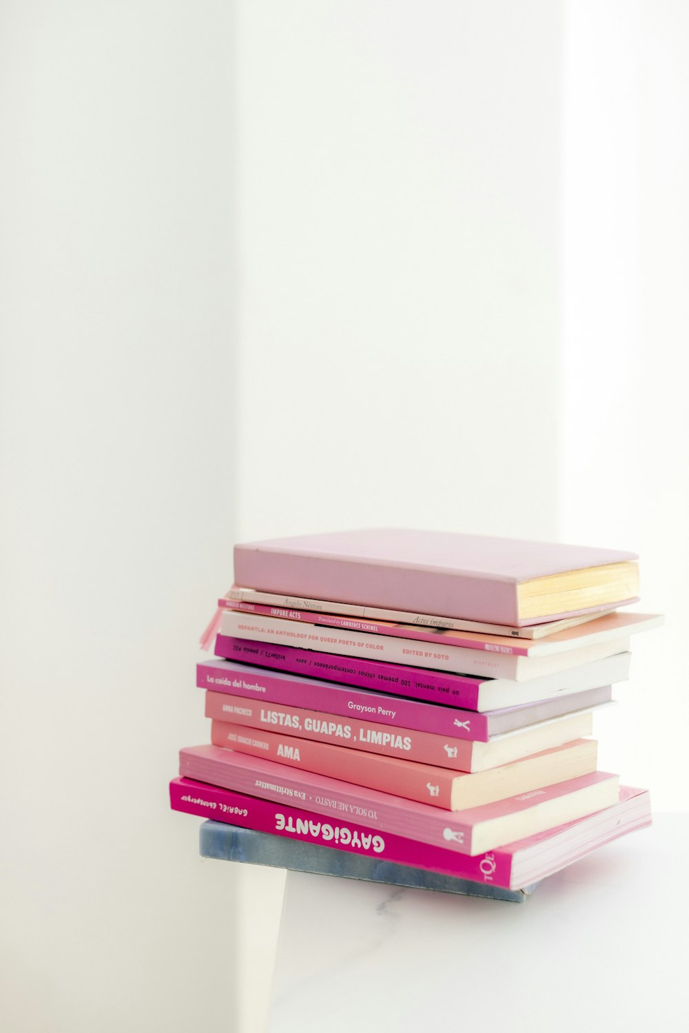 stack of books on white table