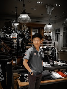 A stylish man browsing clothes in a modern online store interface.