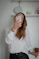 woman in white long sleeve shirt holding iphone 6