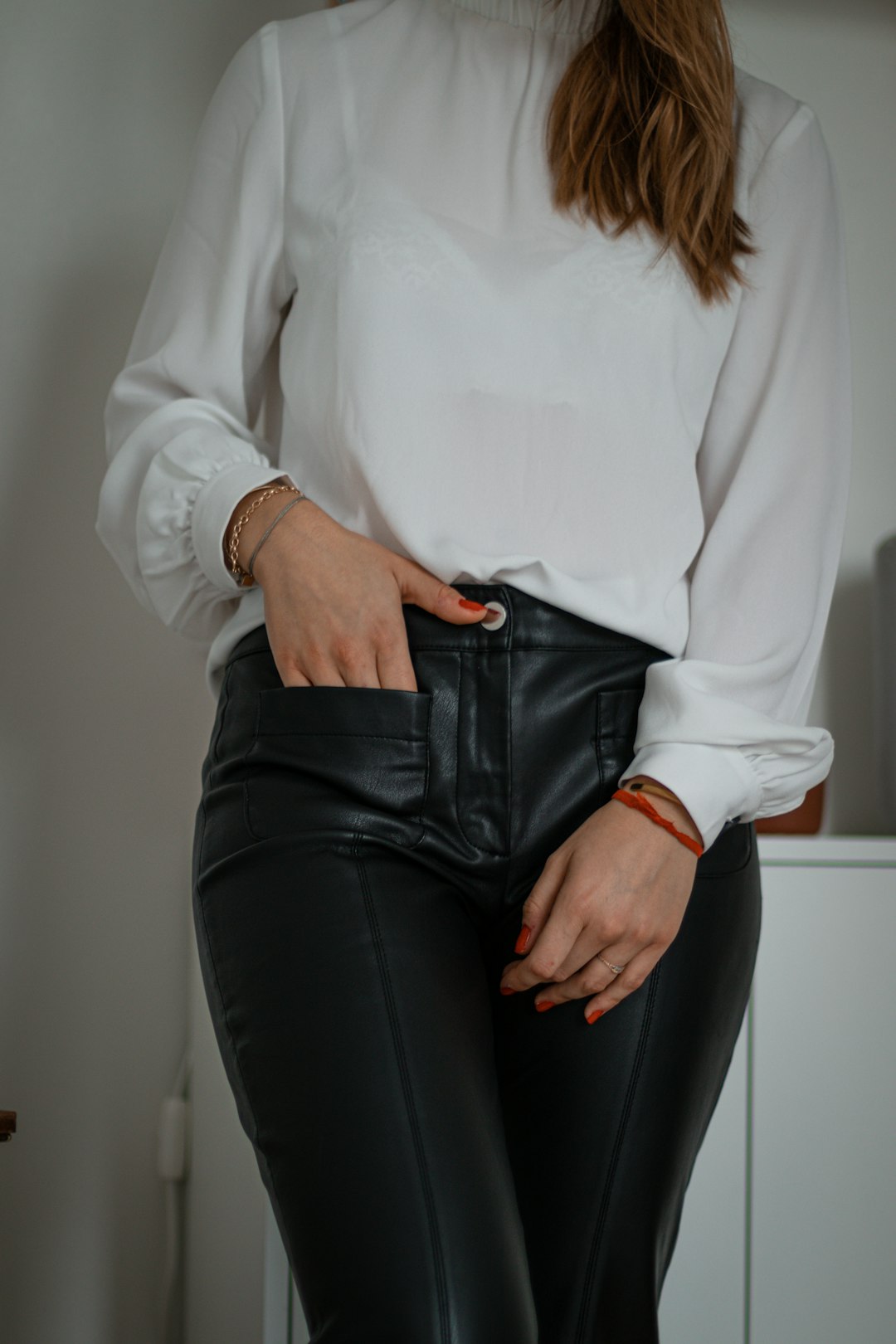 woman in white long sleeve shirt and black pants