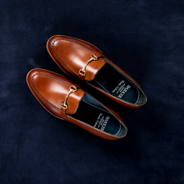 Brown leather horsebit loafers with gold hardware — the Gucci icon