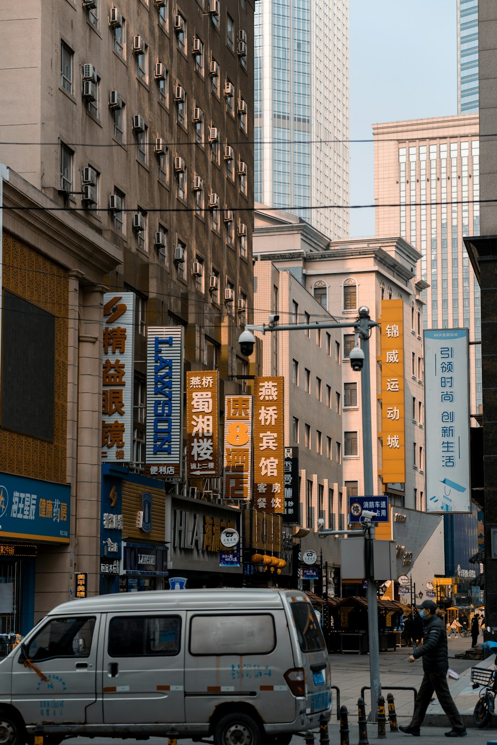 cars parked beside brown concrete building during daytime