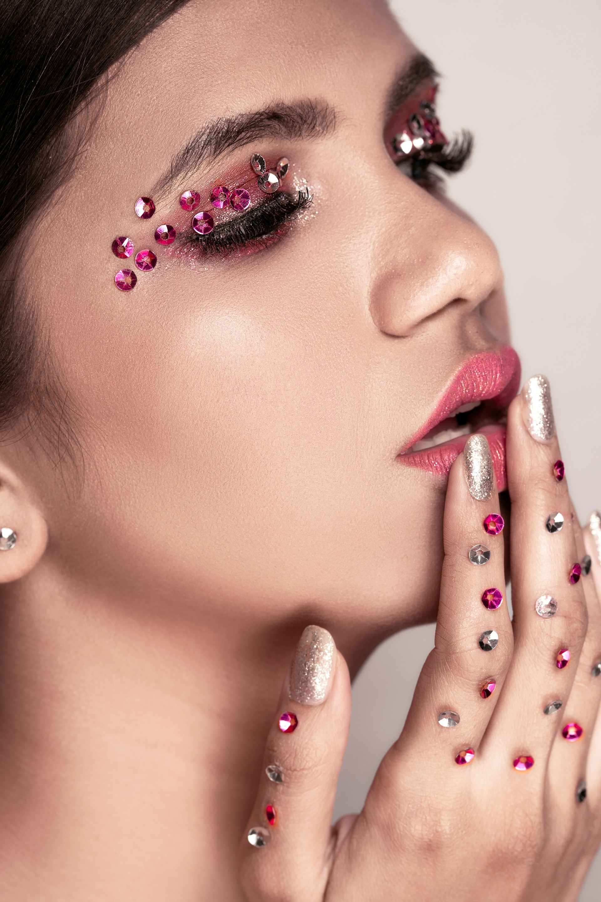 woman with pink lipstick and silver diamond stud earrings