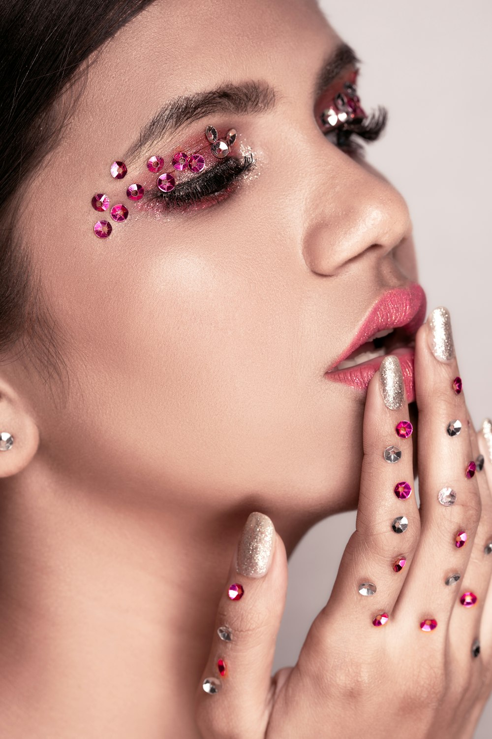 woman with pink lipstick and silver diamond stud earrings