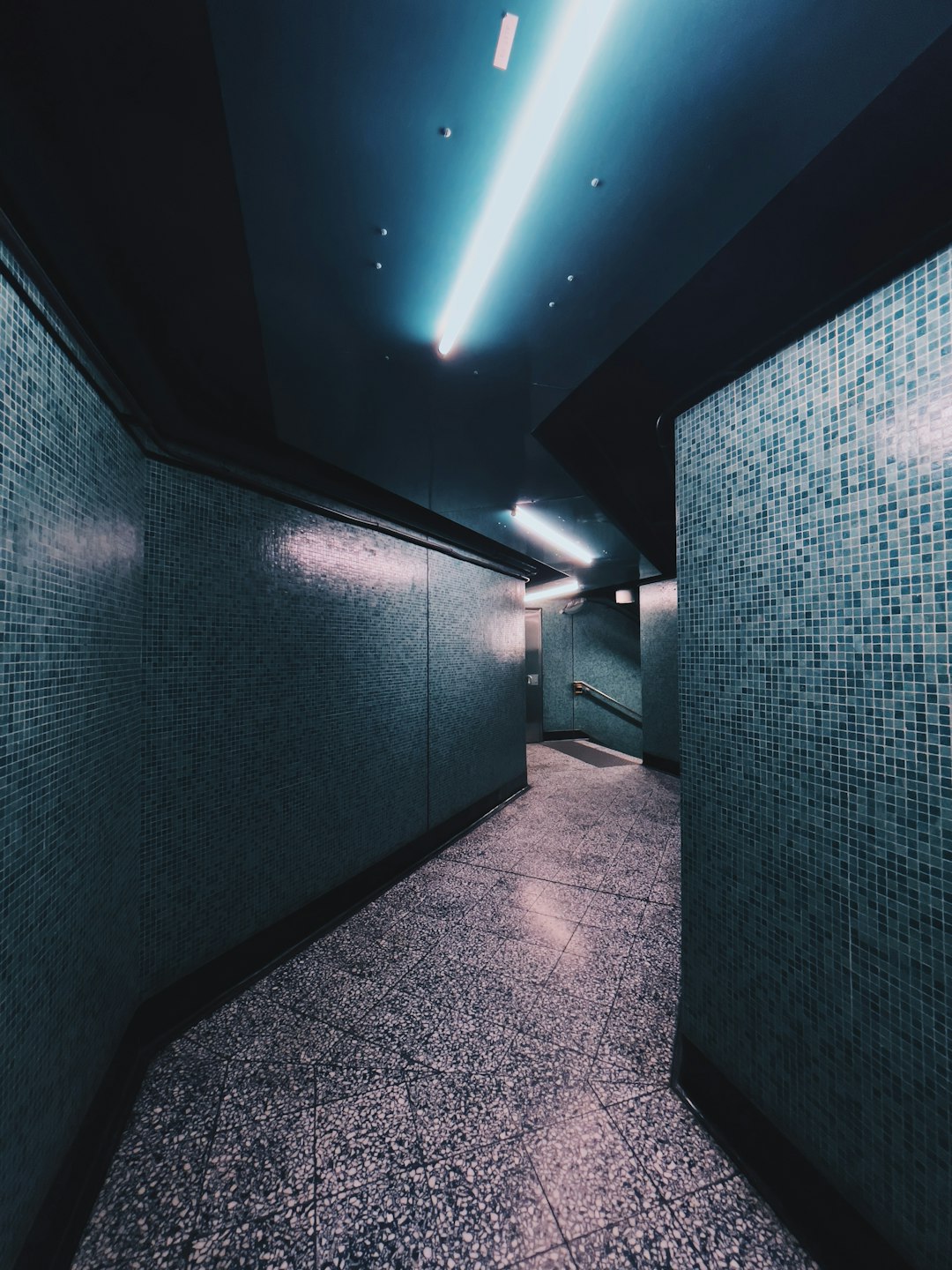 blue and white hallway with lights turned on in room