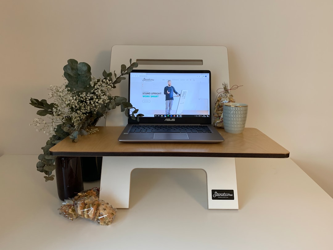 black laptop computer on white wooden desk
