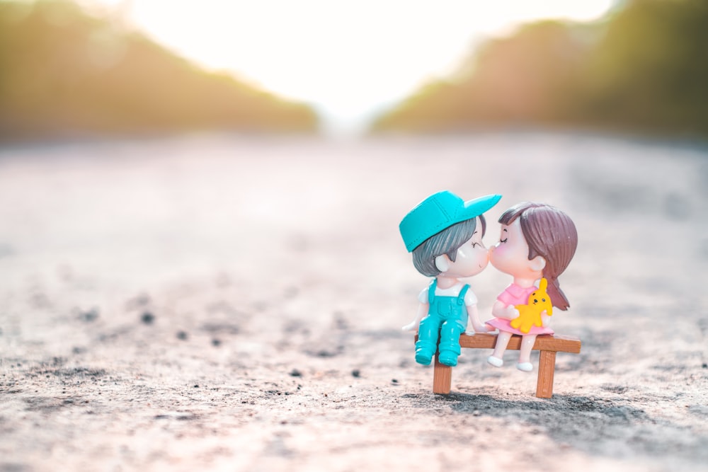 girl in pink jacket holding umbrella walking on beach during daytime