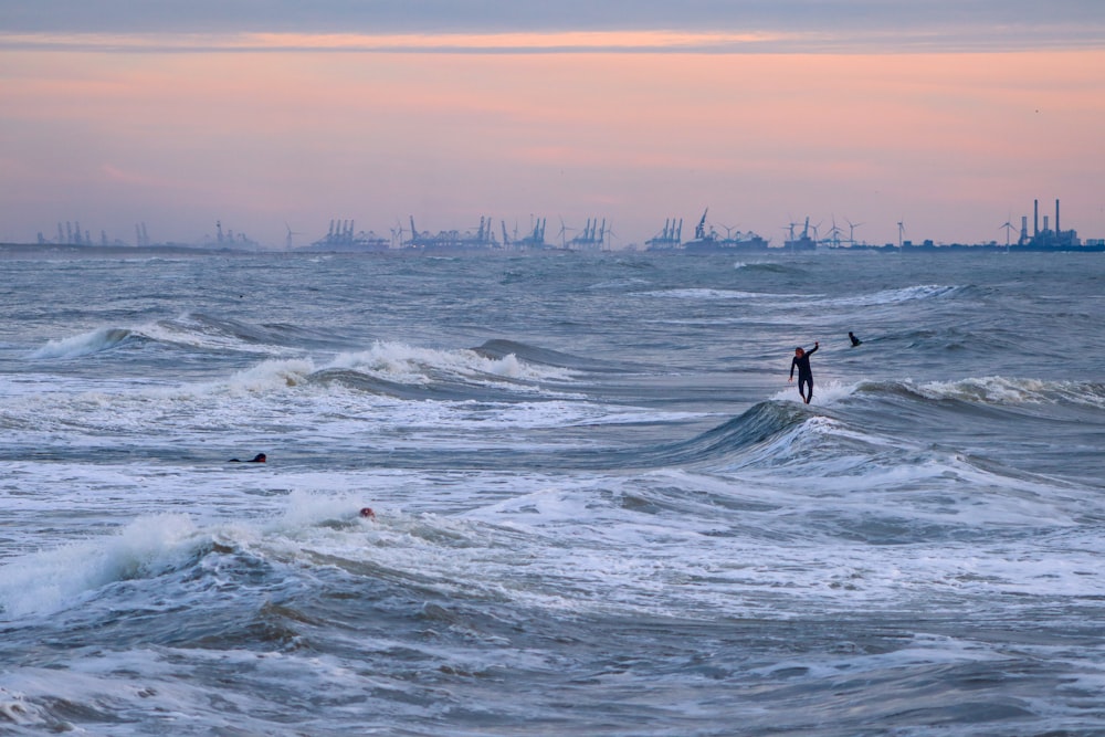 person surfing on sea waves during daytime