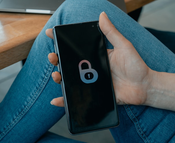 black and white smartphone on persons hand