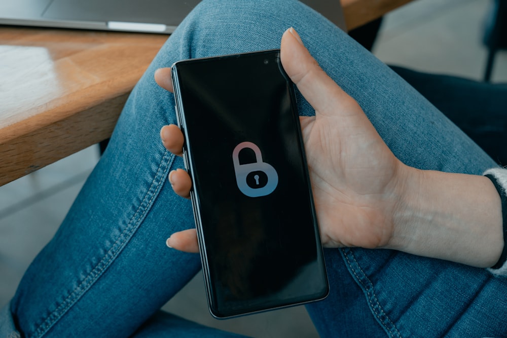 black and white smartphone on persons hand